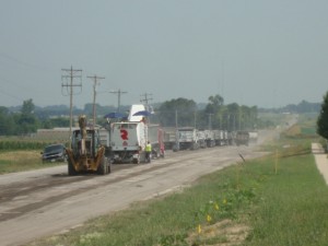 Trucks lined up in front of milling equipment.  7-2-12