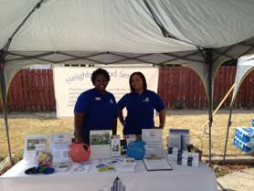 City of Champaign Neighborhood Services staff members Nina Sibley and Mya Clements at the Neighborhood Services Department table