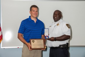 Chief Anthony Cobb presents Sgt. Geoff Coon with the Valor Award