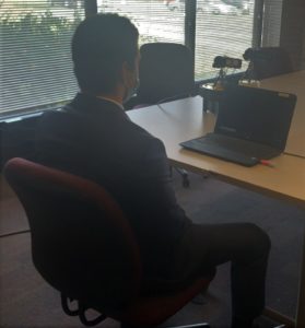 Candidate sits and records interview