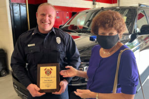 Firefighter Sean Manual Receiving his Award from the Exchange Club