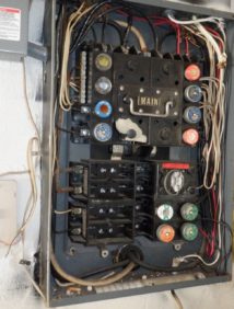 Picture of an open, outdated circuit breaker box
