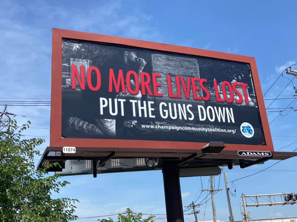 Billboard that reads "No more lives lost, put the guns down"