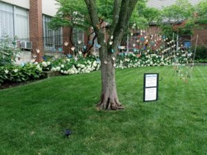 Tree with painted wooden doves hanging from it 