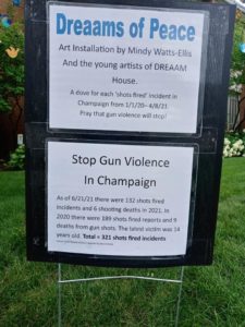 Sign that says Dreeams of peace with gun violence statistics