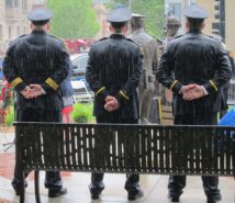 Police Officers stand at attention in the rain