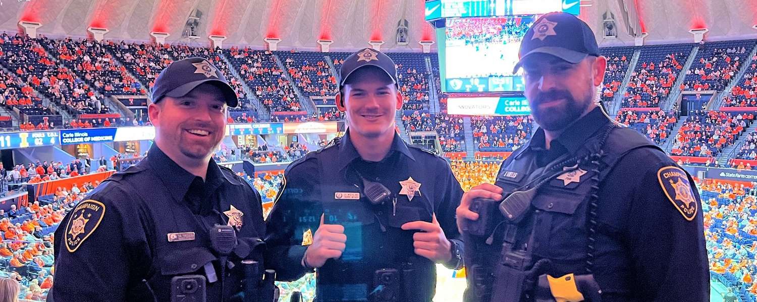 Three CPD Officers pose while on patrol at an Illini Men's Basketball game