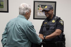 Chief of Police Timothy T. Tyler shakes hands with a resident