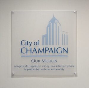 Close up of the wall sign with City logo and mission statement at end of hall