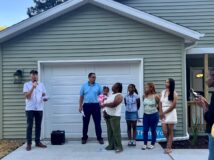 Neighborhood Services Director, Rob Kowalski with the recipient family at the Habitat for Humanity Home Dedication